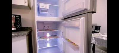 an empty refrigerator with its door open in a kitchen at La bonita studio in Hurghada