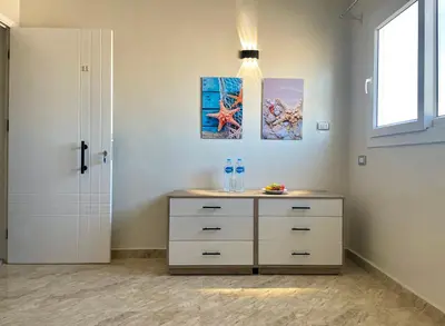 a bedroom with a dresser and a window at Divers Home Safaga in Safaga