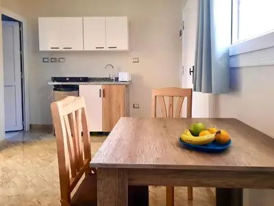 a kitchen with a wooden table with a bowl of fruit on it at Divers Home Safaga in Safaga