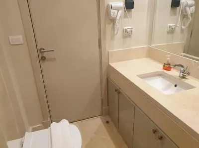 a bathroom with a shower with a sink and a toilet at Mangroovy - 2BR Prodigious Ground Pool & Sea view in Hurghada
