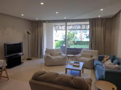 a living room with two couches and a tv at Mangroovy - 2BR Prodigious Ground Pool & Sea view in Hurghada