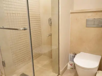 a bathroom with a shower and a toilet at Mangroovy- 1BR Sea Breeze Back Sea view in Hurghada