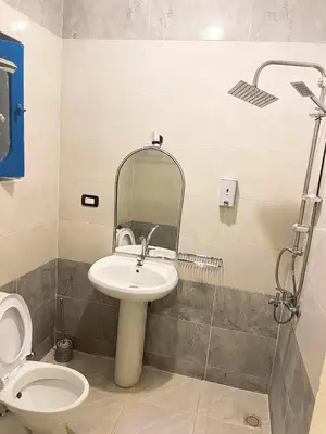 a bathroom with a sink and a toilet and a mirror at فندق جولدن صن العروسه طريق الشيراتون السقالة ميدان محافظة البحر الأحمر 84511 مصر in Hurghada