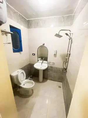 a bathroom with a toilet and a sink at فندق جولدن صن العروسه طريق الشيراتون السقالة ميدان محافظة البحر الأحمر 84511 مصر in Hurghada
