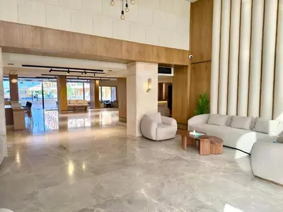 a lobby with couches and tables in a building at Selena bay Resort with private beach - Voyage de rêve in Hurghada