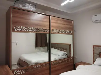 a bedroom with two beds and a large wooden bunk bed at Selena bay Resort with private beach - Voyage de rêve in Hurghada