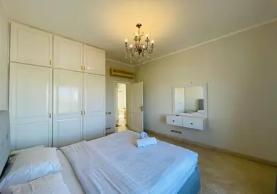 a bedroom with a bed and a mirror and a chandelier at Unique Villa 6 B Rooms Villa 38 at El-Gouna in Hurghada