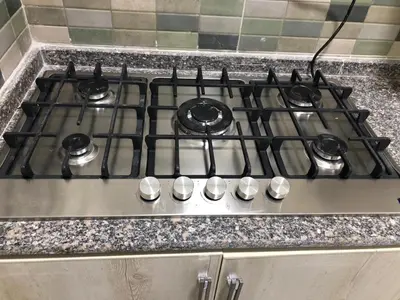 a stove top with four burners on a kitchen counter at New Villa Carimo in Quseir
