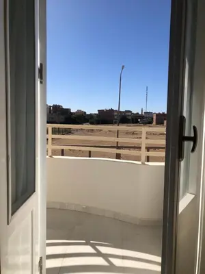 an open door with a view of a parking lot at New Villa Carimo in Quseir