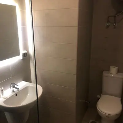 a bathroom with a toilet and a sink at Hotel Apartment in G cribs in Hurghada