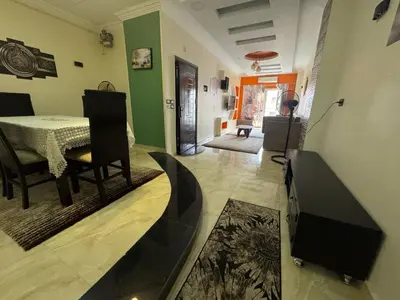a living room with a table and a dining room at Hurghada Sea View Apartment in Hurghada