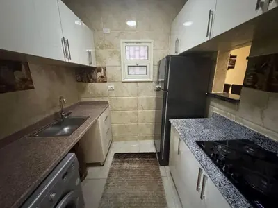 a small kitchen with a sink and a refrigerator at Hurghada Sea View Apartment in Hurghada