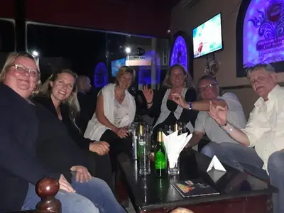 a group of people sitting in a bar waving at Hurghada Sea View Apartment in Hurghada