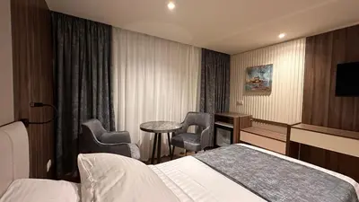 a hotel room with a bed and a table and chairs at book Now Nile Cruise From Aswaon every Friday & Monday & wednesday in Aswan