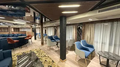 a waiting room with blue chairs and tables at book Now Nile Cruise From Aswaon every Friday & Monday & wednesday in Aswan