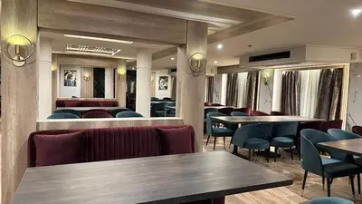 a restaurant with wooden tables and chairs and tablesktop at book Now Nile Cruise From Aswaon every Friday & Monday & wednesday in Aswan