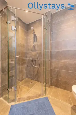 a shower with a glass door in a bathroom at Ollystays Ancient Sands 4 BR Villa Heated Pool in Hurghada