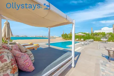 a patio with a tent and a swimming pool at Ollystays Ancient Sands 4 BR Villa Heated Pool in Hurghada