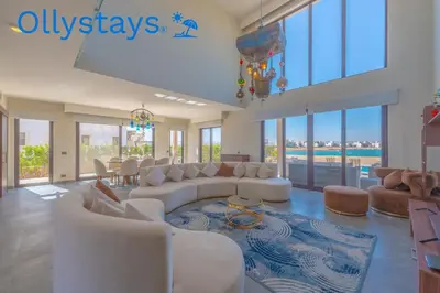 a large living room with white couches and a table at Ollystays Ancient Sands 4 BR Villa Heated Pool in Hurghada
