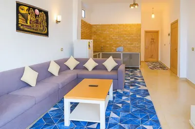 a living room with a couch and a table at Villa Desert Rose in Luxor