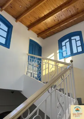 a staircase in a house with blue windows at Gîte Hôtel Ramla Louxor 2 in Luxor
