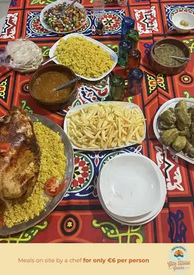 a table with many plates of food on it at Gîte Hôtel Ramla Louxor 2 in Luxor
