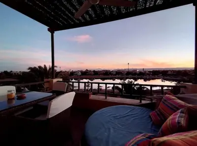 a patio with a view of a body of water at Soulful 1BR in Italian Compound / Nubia, El Gouna in Hurghada
