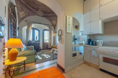 a kitchen with an archway and a living room at Soulful 1BR in Italian Compound / Nubia, El Gouna in Hurghada