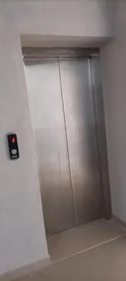 a metal shower stall with a door in a bathroom at Relaxing open Seaview Apartment in Hurghada