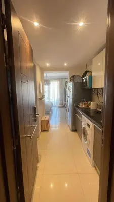 a small kitchen with a refrigerator and a washer and dryer at Studio G Cribs El Gouna in Hurghada