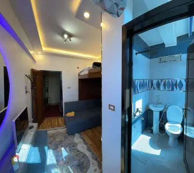 a room with a couch and a toilet at Unique studio in Aswan