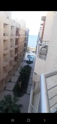 a view from a balcony of a building with palm trees at Kazpilkna Beach Neighborhoods in Hurghada