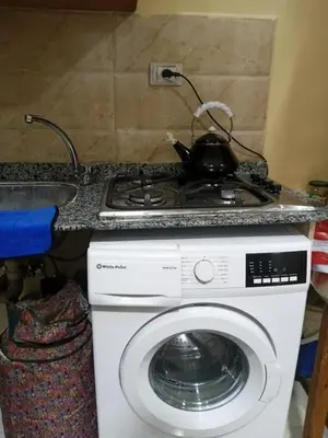 a stove with a tea pot on top of a washing machine at Kazpilkna Beach Neighborhoods in Hurghada