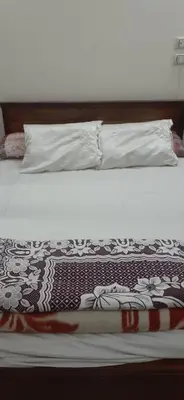 a bed with a black and white blanket on it at Kazpilkna Beach Neighborhoods in Hurghada