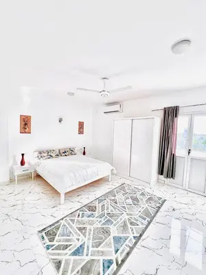 a white bedroom with a bed and a marble floor at Muhammad Ali House in Luxor