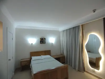 a bedroom with a bed and a mirror and lights at Sunset pearl, Sahl Hashish in Hurghada