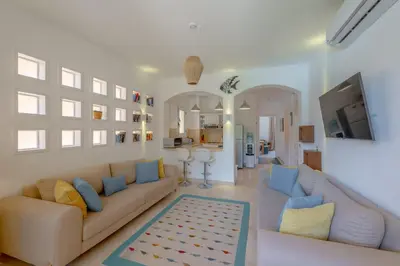a living room with two couches and a tv at Charming Apartment with Pool in prime location in Hurghada