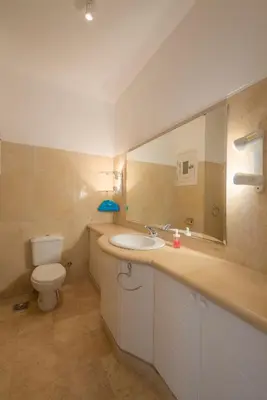 a bathroom with a sink and a toilet and a mirror at Charming Apartment with Pool in prime location in Hurghada