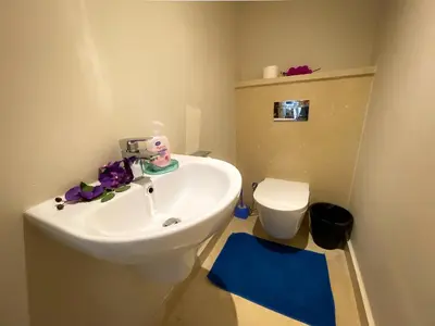 a bathroom with a sink and a toilet at Apartment with large terrace & nice pool area in Hurghada