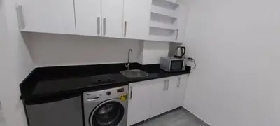 a kitchen with a sink and a washing machine at Studio Sleeps 2 with Balcony Pool & Parking in Hurghada