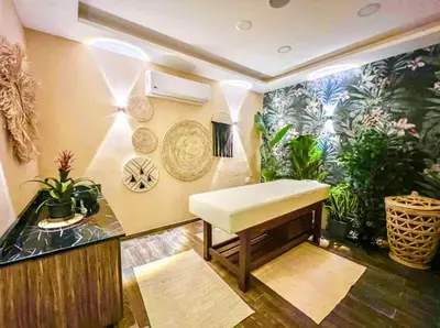 a room with a bench and plants on the wall at Studio Sleeps 2 with Balcony Pool & Parking in Hurghada