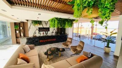 a living room with a couch and a fireplace at Studio Sleeps 2 with Balcony Pool & Parking in Hurghada