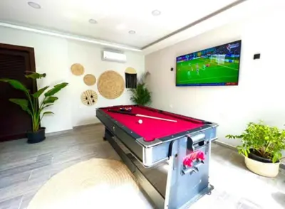 a pool table in a living room with a tv at Studio Sleeps 2 with Balcony Pool & Parking in Hurghada
