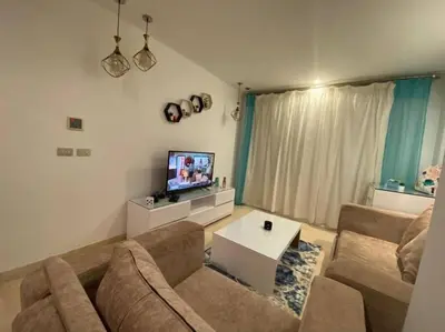 a living room with a couch and a tv at one bedroom scarab club el gouna in Hurghada