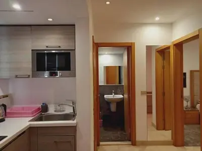 a kitchen with a sink and a bathroom with a mirror at one bedroom scarab club el gouna in Hurghada