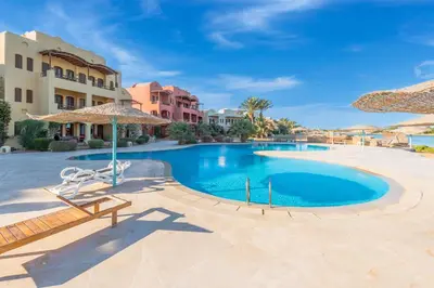 a swimming pool at the resort with umbrellas at Special style apartment with pool at lagoon in Hurghada