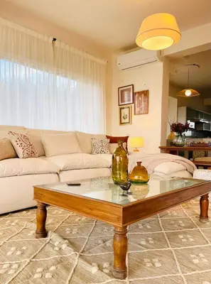 a living room with a couch and a coffee table at 4BR Villa with Private Pool in Gouna in Hurghada
