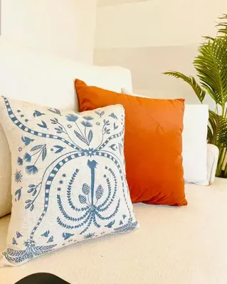 an orange and white pillow sitting on a couch at 4BR Villa with Private Pool in Gouna in Hurghada