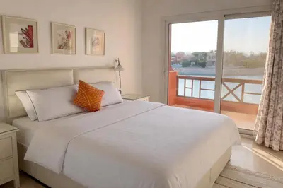 a bedroom with a bed and a large window at 4BR Villa with Private Pool in Gouna in Hurghada