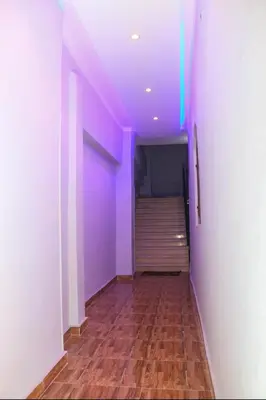 a hallway with a purple ceiling and a wooden floor at Shahd House in Luxor